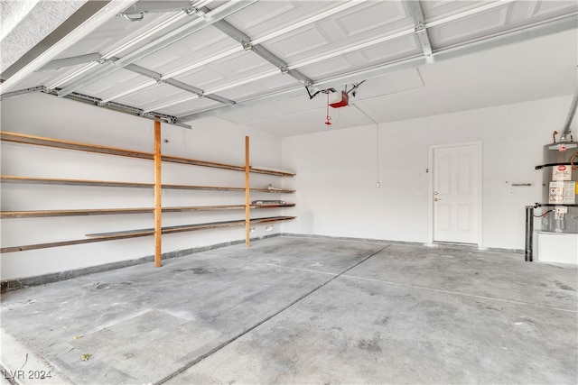 garage with strapped water heater and a garage door opener