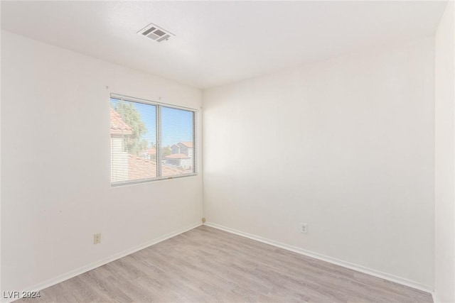 unfurnished room with light wood-type flooring