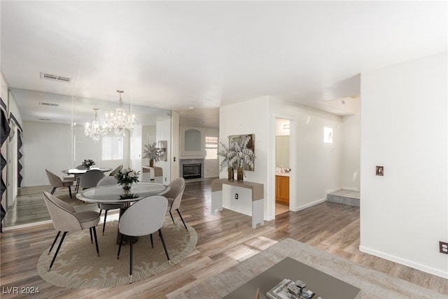 dining space with a notable chandelier and wood-type flooring