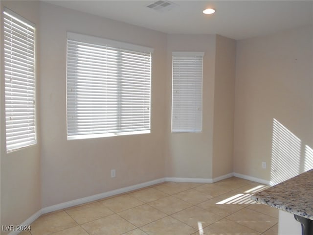 unfurnished room featuring light tile patterned floors