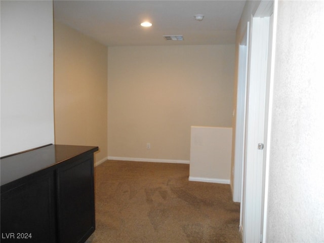 spare room with dark colored carpet