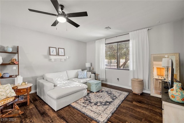 living room featuring dark hardwood / wood-style flooring and ceiling fan