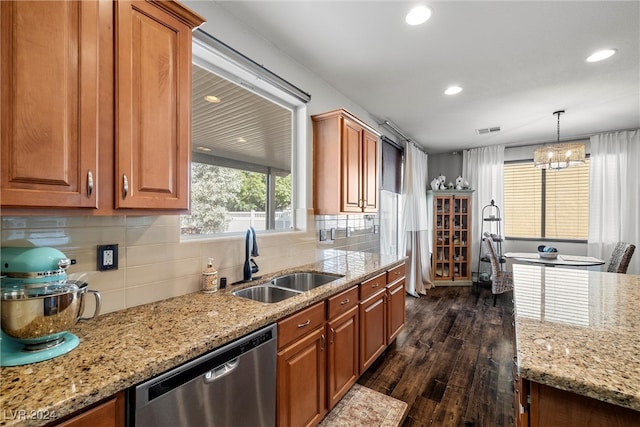 kitchen with dark wood-type flooring, stainless steel dishwasher, a chandelier, pendant lighting, and sink