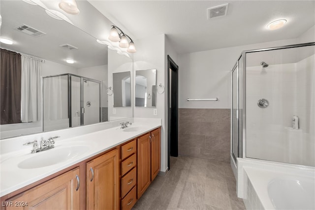 bathroom with shower with separate bathtub and vanity