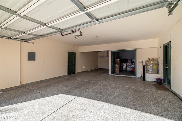 garage featuring electric panel, a garage door opener, and strapped water heater