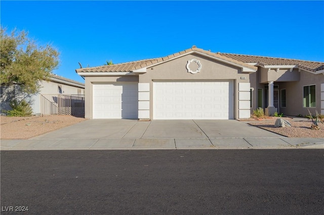 view of front of property with stucco siding, driveway, and an attached garage