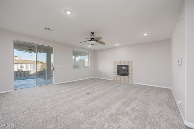 unfurnished living room featuring visible vents, baseboards, and ceiling fan