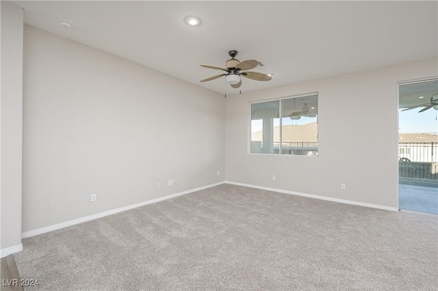 carpeted empty room featuring ceiling fan and a healthy amount of sunlight