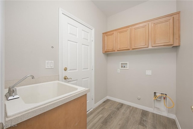 laundry room with washer hookup, cabinets, hookup for a gas dryer, and light hardwood / wood-style floors