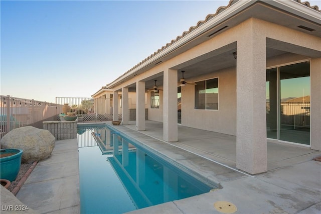 view of pool featuring a patio area, a fenced in pool, a fenced backyard, and ceiling fan