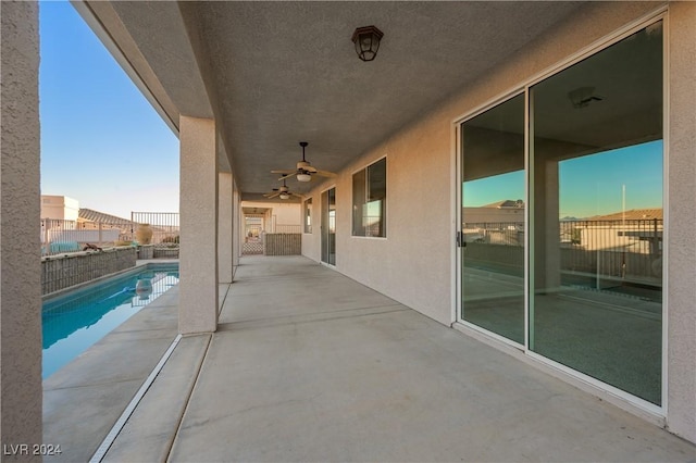 view of patio with a fenced in pool, ceiling fan, and fence