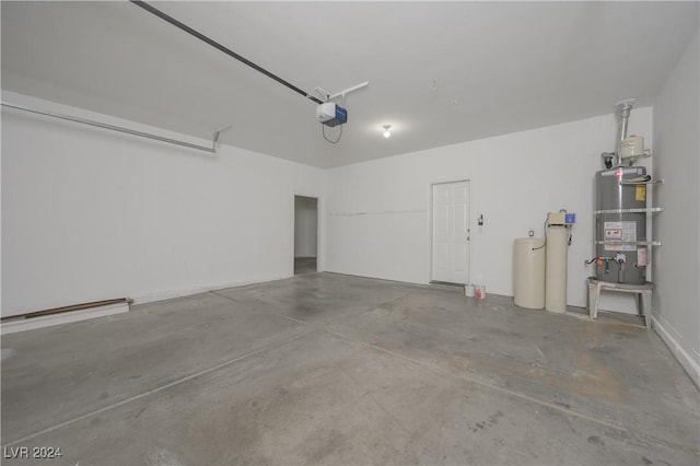 garage with a garage door opener and secured water heater