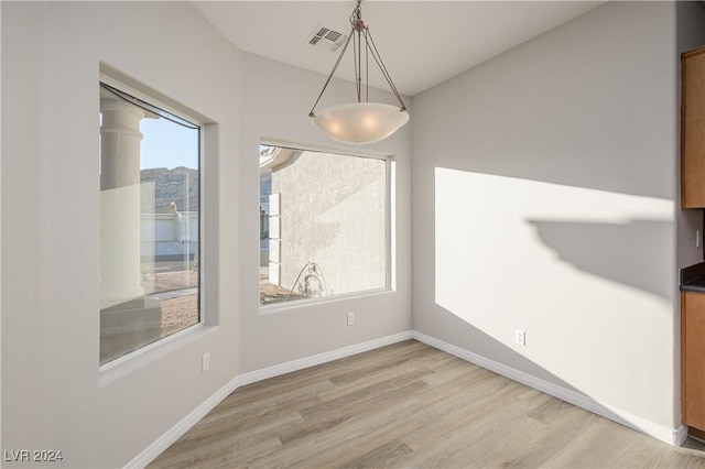 unfurnished dining area featuring wood-type flooring