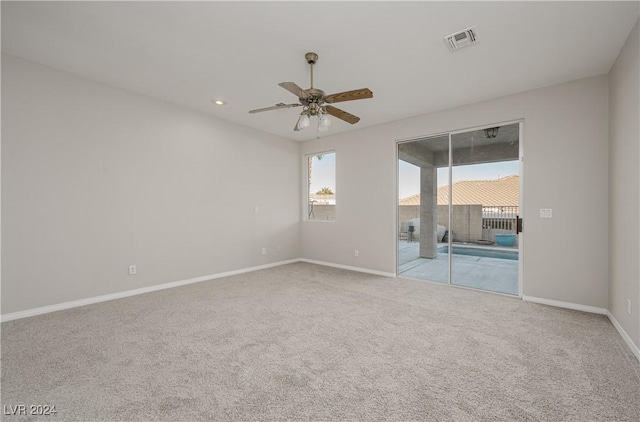 unfurnished room featuring ceiling fan and light colored carpet