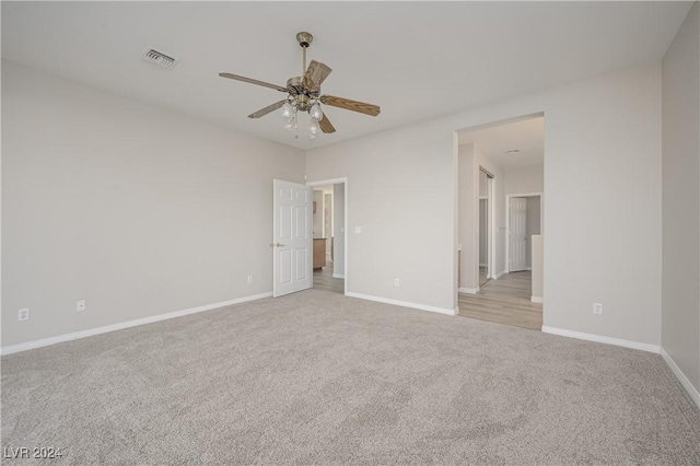 unfurnished bedroom with visible vents, baseboards, a ceiling fan, and carpet flooring