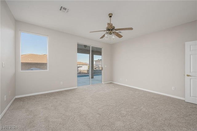 unfurnished room featuring a ceiling fan, carpet, visible vents, and baseboards