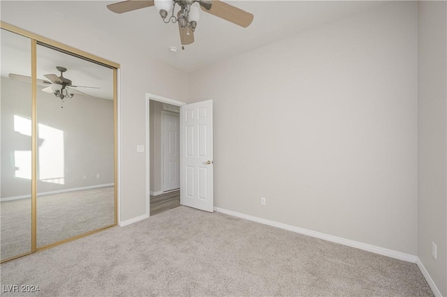 unfurnished bedroom with ceiling fan, a closet, and light colored carpet