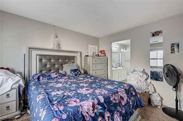 bedroom with ensuite bathroom and carpet floors