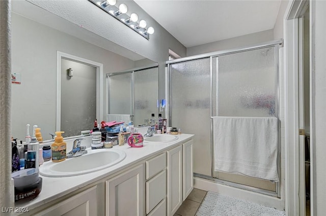 bathroom featuring tile patterned floors, vanity, and walk in shower