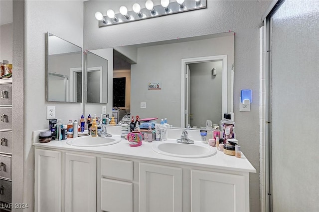 bathroom featuring vanity and a shower with door