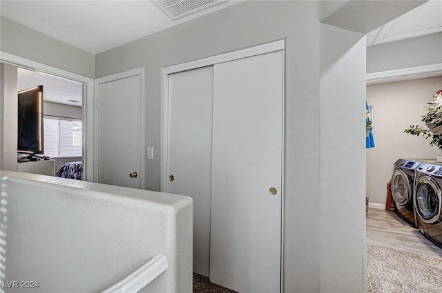 bathroom featuring hardwood / wood-style floors and independent washer and dryer