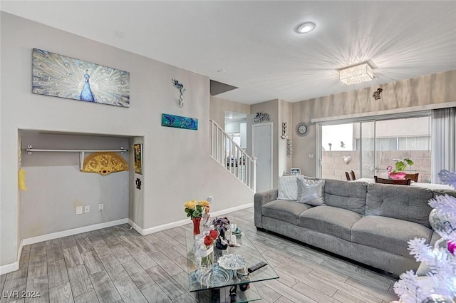 living room with a chandelier and light hardwood / wood-style flooring