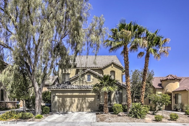 mediterranean / spanish-style home with a garage