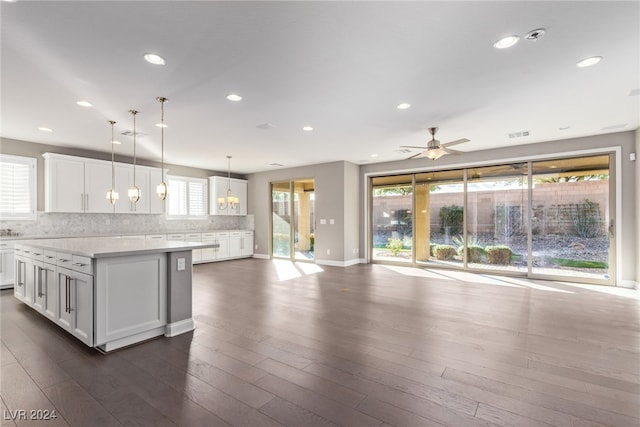 kitchen featuring pendant lighting, a center island, dark hardwood / wood-style floors, and white cabinetry