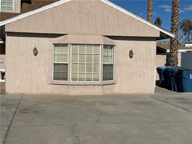 view of property exterior featuring a patio area