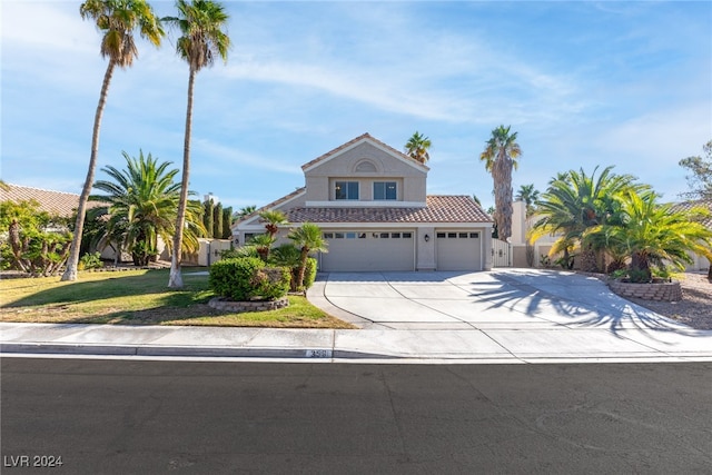 view of front of property with a front yard and a garage