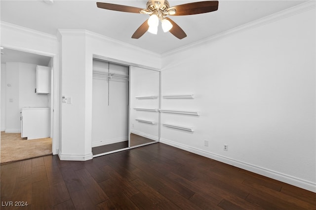 unfurnished bedroom with crown molding, ceiling fan, a closet, and dark wood-type flooring