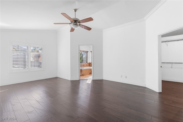 spare room with dark hardwood / wood-style floors, a healthy amount of sunlight, lofted ceiling, and ornamental molding