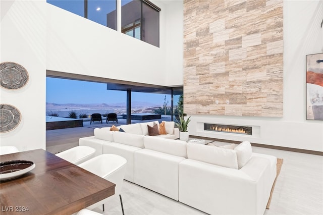 living room with a large fireplace and a high ceiling