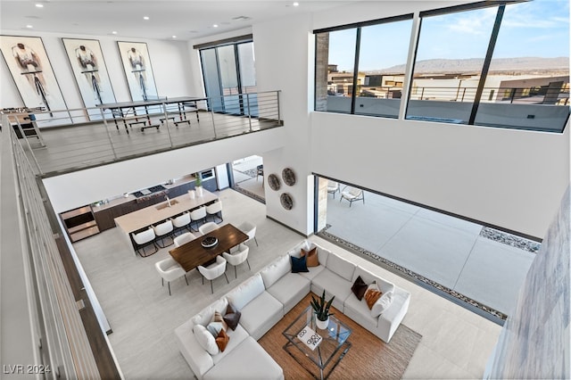 unfurnished living room featuring a mountain view and light tile patterned flooring