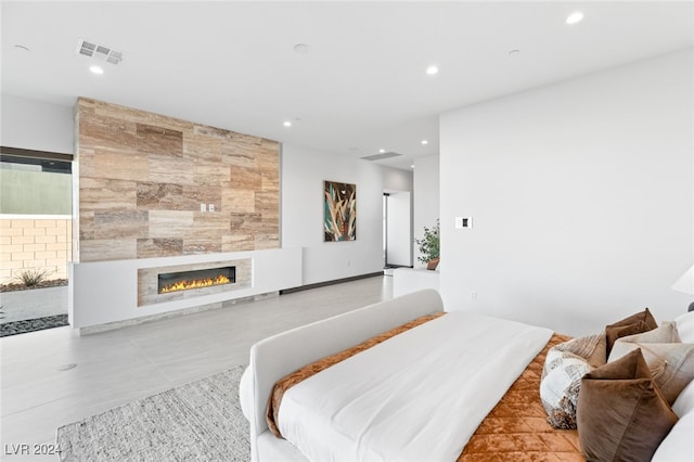 bedroom featuring a tiled fireplace