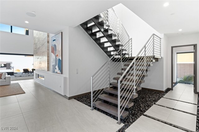 staircase featuring tile patterned floors and a wealth of natural light