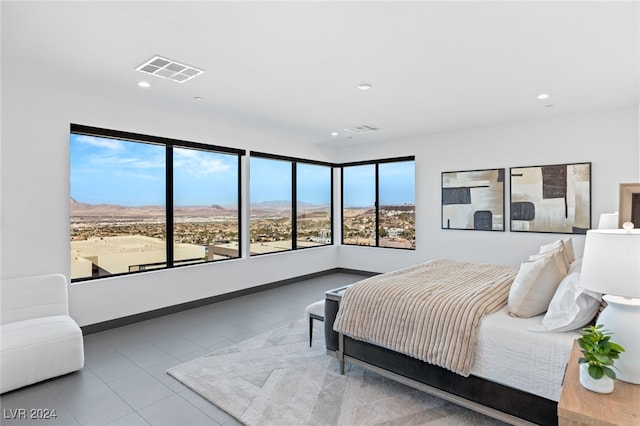 bedroom with light tile patterned flooring and multiple windows