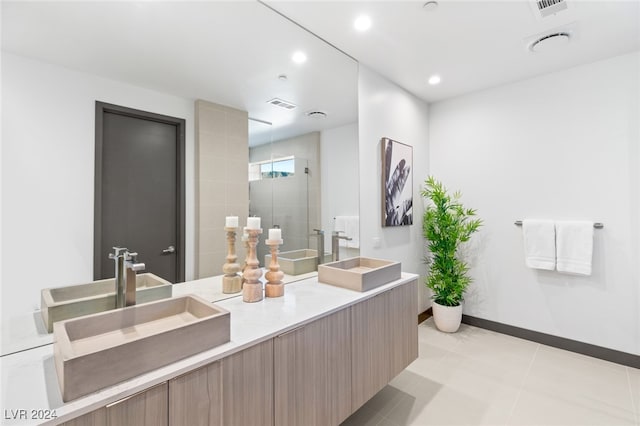 bathroom featuring tile patterned flooring, vanity, and an enclosed shower