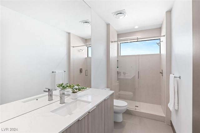 bathroom with tile patterned floors, vanity, toilet, and walk in shower