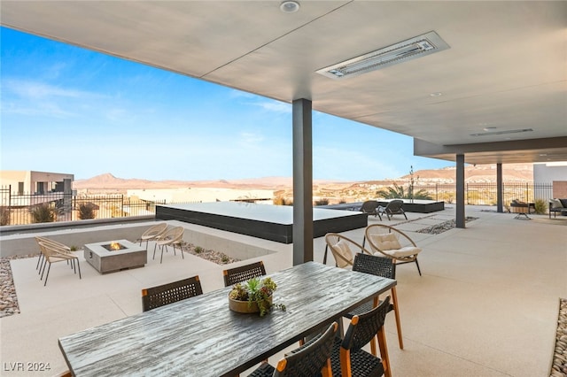 view of patio / terrace featuring a mountain view and an outdoor fire pit