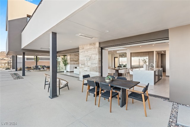 view of patio with an outdoor kitchen and sink