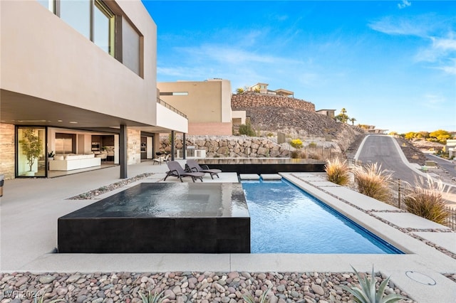 view of pool featuring a patio area and pool water feature