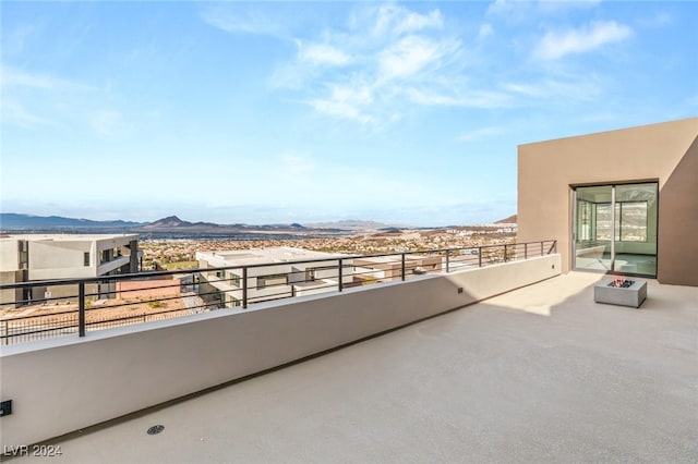 view of patio / terrace with a fire pit and a mountain view