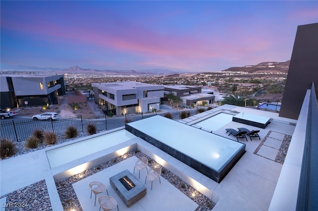 aerial view at dusk featuring a mountain view