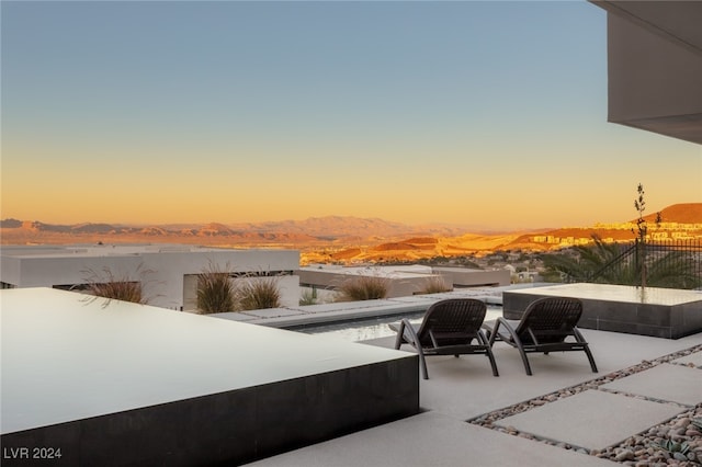 patio terrace at dusk with a mountain view