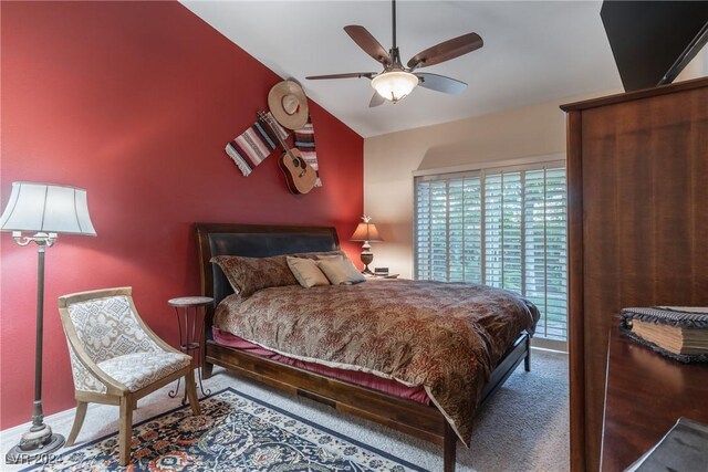 carpeted bedroom with ceiling fan and lofted ceiling