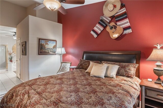 tiled bedroom featuring ensuite bath and ceiling fan