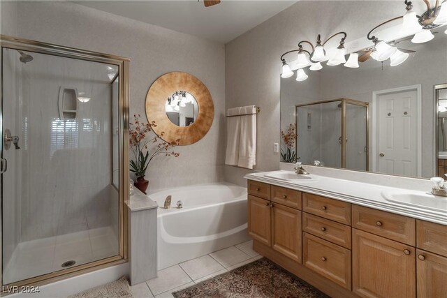 bathroom with tile patterned floors, vanity, and separate shower and tub