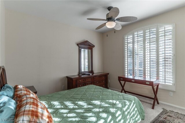 carpeted bedroom featuring multiple windows and ceiling fan