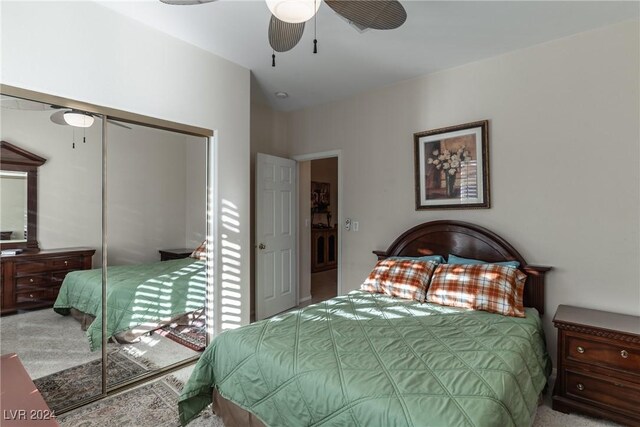 bedroom featuring ceiling fan, a closet, carpet floors, and lofted ceiling